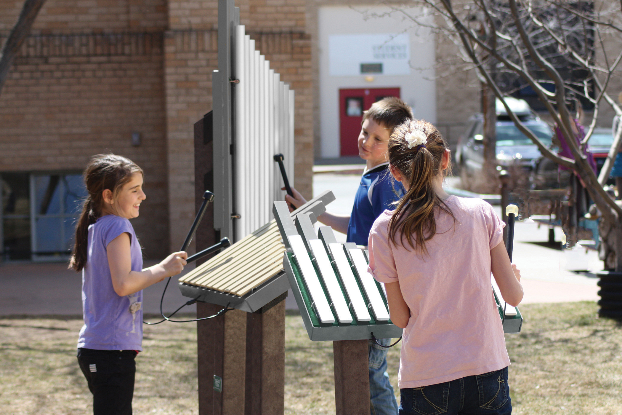 Children playing on outdoor musical instruments