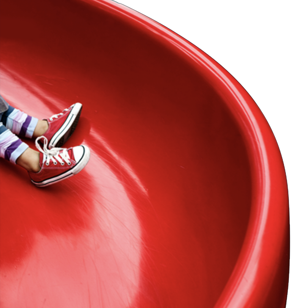 Child sliding down red slide